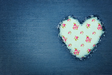 Green floral vintage heart shape for copy space torn from blue denim jeans fabric, romantic love...