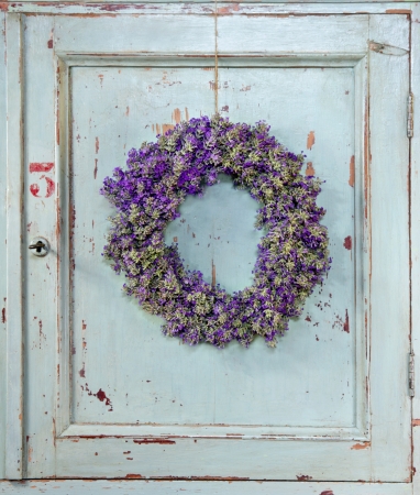 Lavender flower wreath hanging on an old wooden vintage kitchen door frame with copy spaceの写真素材
