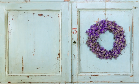 Lavender flower wreath hanging on an old wooden vintage kitchen door frame with copy spaceの写真素材