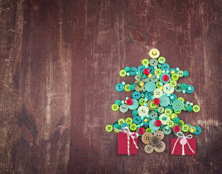 Green and red buttons as decorative Christmas tree on wooden vintage backgroundの写真素材