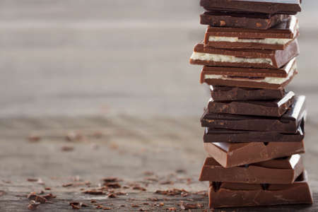 Piles of chocolate on wooden rustic bakcgroundの写真素材