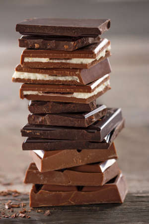 Piles of chocolate on wooden rustic bakcgroundの写真素材