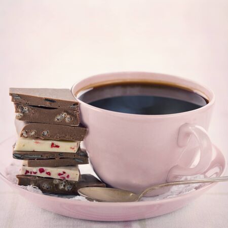Pile of chocolate and coffee in a pink cup