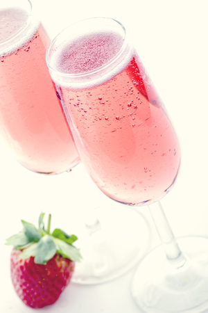 Pink champagne with strawberries and creamy vintage editingの写真素材