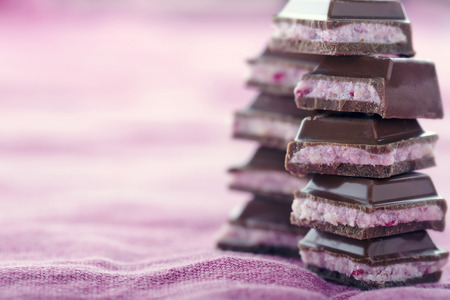 Stacks of chocolate on pink backgroundの写真素材