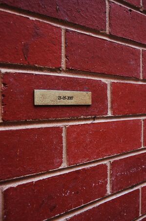 sign on brick wallの写真素材