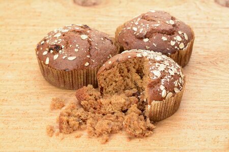 Cinnamon muffins on wooden table