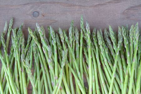 Asparagus on wooden table at marketの写真素材
