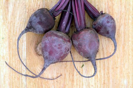 Four beetroots on wooden table