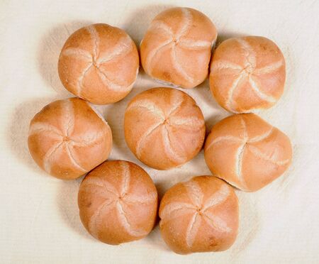Kaiser style bread bun on the tableの写真素材