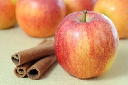 apples and cinnamon on tableの写真素材