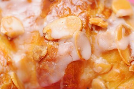 Closeup croissant topping with nuts for background usesの写真素材