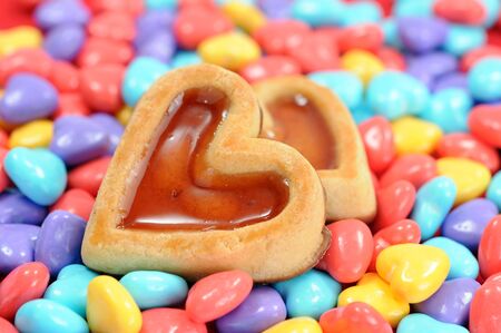 colorful heart shape candies and heart shape caramel cakes