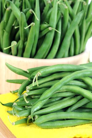 green beans in wooden bowl ready for cookingの写真素材
