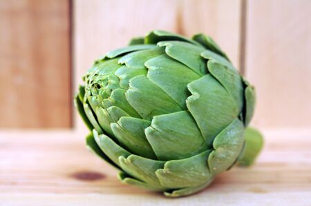 Fresh artichoke on wooden table at market placeの写真素材