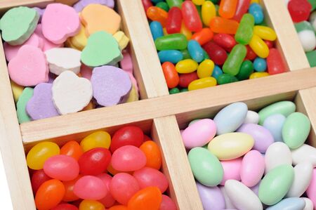 assorted colorful fruit flavor candies in wooden boxの写真素材