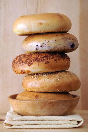 five bagels on napkin on wooden shelf の写真素材
