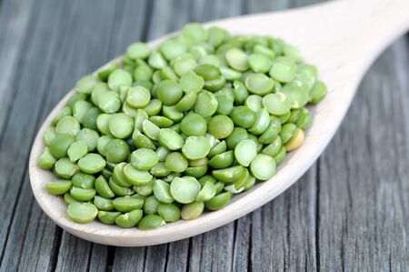 a pile of green split pea on grunge background