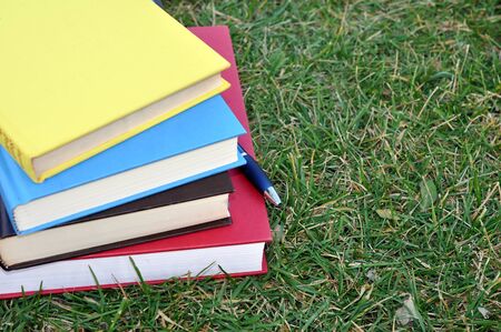 colorful books on grass in campusの写真素材