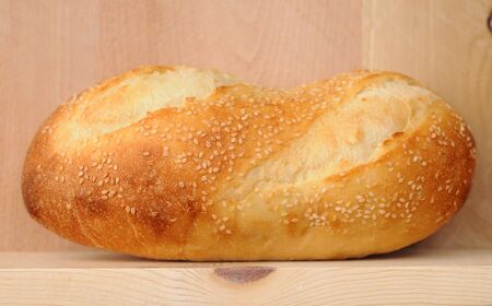 single sesame seed bread isolated on white background