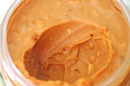 closeup of openned peanut butter jar