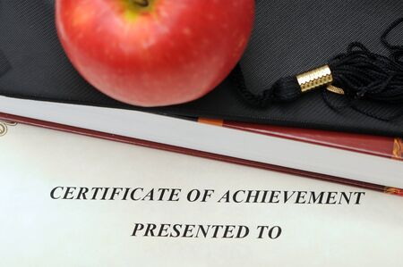 concept of education with certificate, apple, book and graduated capの写真素材