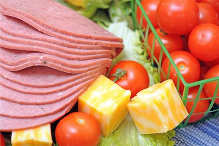 slice ham, cheese, salad and cherry tomatoの写真素材