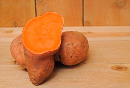sweet potatoes on wooden shelfの写真素材