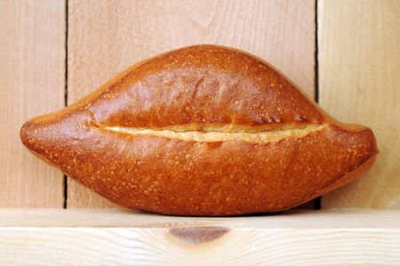 single  bread on wooden shelf