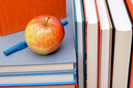 books, pen and apple for education decorationの写真素材