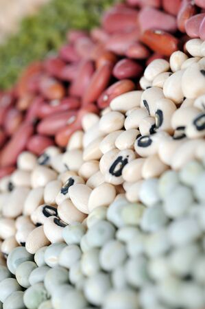 closeup of green pea, black eyes and light red bean focus on black eyes bean