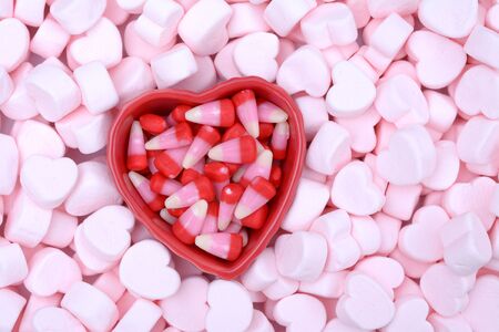 pink marshmallow bowl on candy corn for Valentine Dayの写真素材