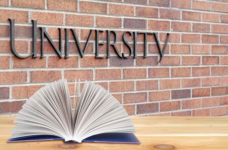 open book on the wooden table in the university campusの写真素材