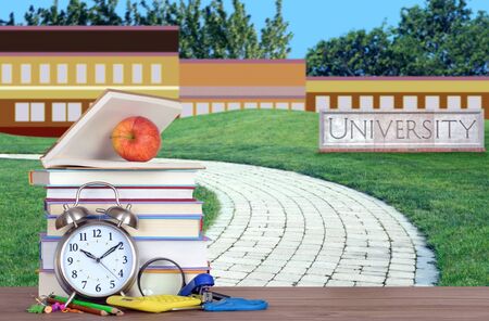 open book on the wooden table in front of universityの写真素材