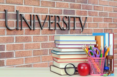open book on the wooden table in front of universityの写真素材