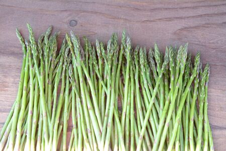 closeup of fresh asparagus on wooden tableの写真素材