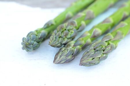 a bunch of asparagus  on the rustic wooden tableの写真素材