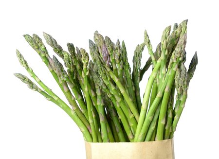 fresh asparagus bunch in paper bag isolated on whiteの写真素材