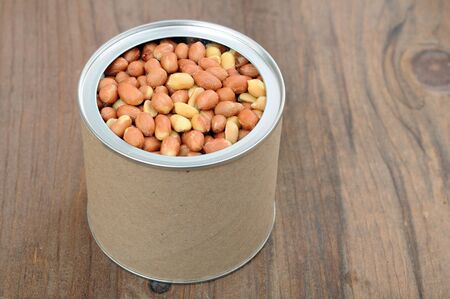 closeup can of salted peanut on rustic table