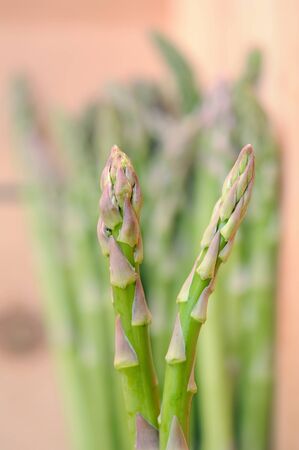 closeup of fresh asparagus  on wooden tableの写真素材