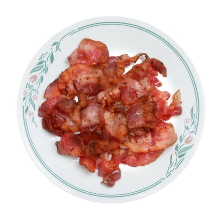  fried Bacon strips on dish isolated on white background の写真素材