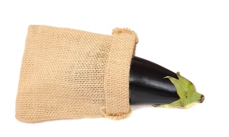 eggplant in burlap bag on white backgroundの写真素材
