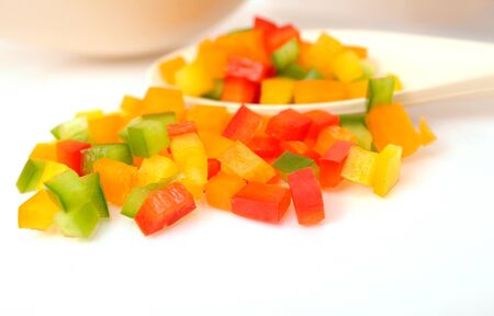colorful chopped bell peppers on white background 