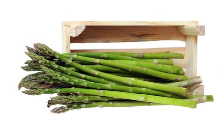 fresh asparagus falling out crate isolated on white backgroundの写真素材