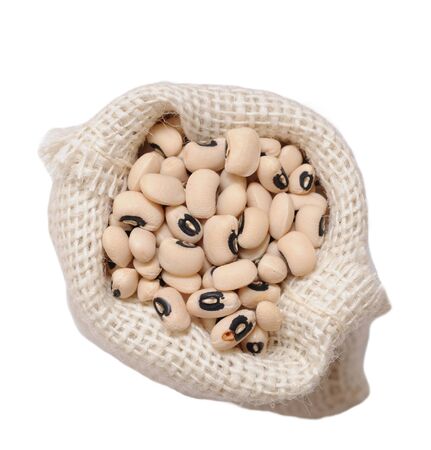 heap of black eyes beans on burlap bag on white backgroundの写真素材