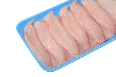 fresh filleted tilapia on tray isolated on white backgorund の写真素材