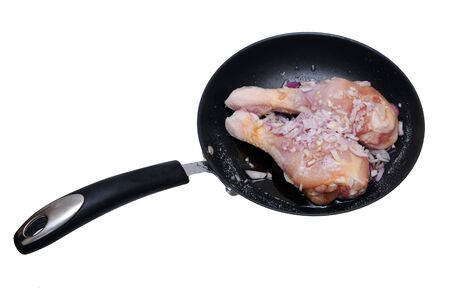 chicken drumsticks on pan isolated on whiteの写真素材