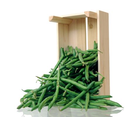 green beans fall off from crate on white background
