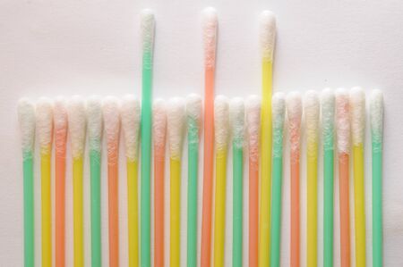 colorful q tips arranged on grey backgroundの写真素材