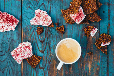 Morning coffee and cookies on a rustic, old wooden table.
